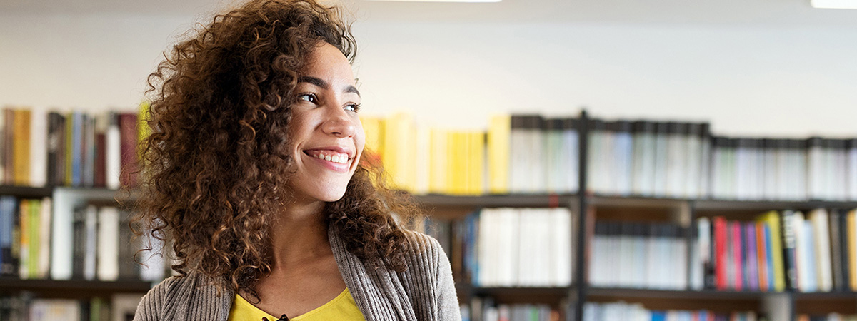 A woman smiling and looking to her left.