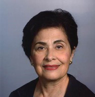 A woman with short hair and wearing a black jacket.