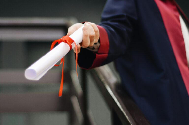student holding diploma