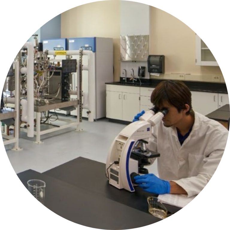 Man looking into microscope