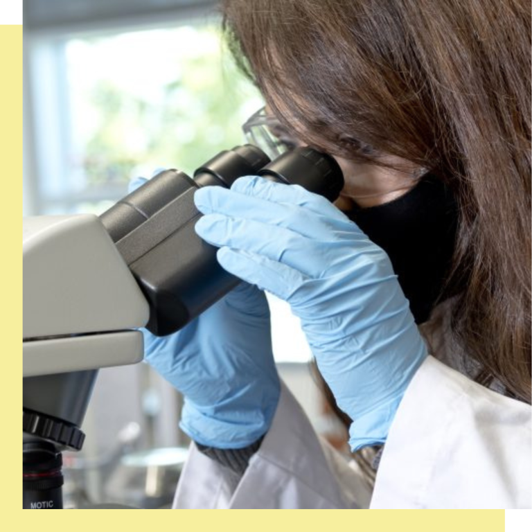 woman looking in microscope